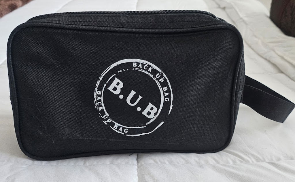 Black toiletry bag with 'B.U.B.' logo on a light background